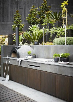 Outdoor pizza oven in a terraced garden